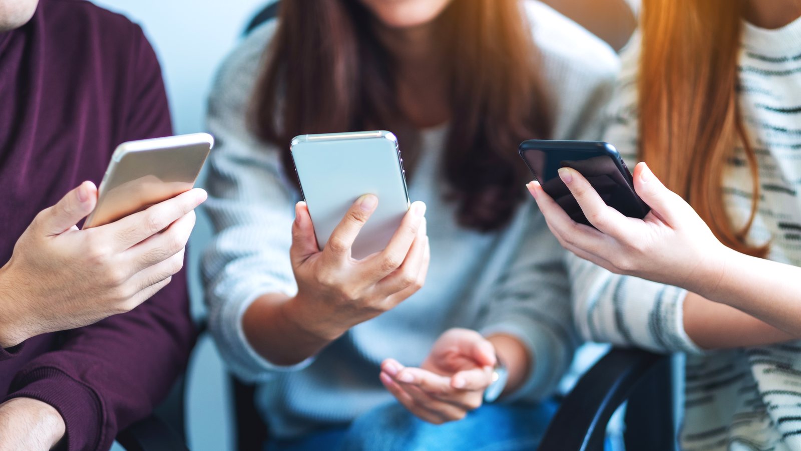 Group of friends looking at a phone together