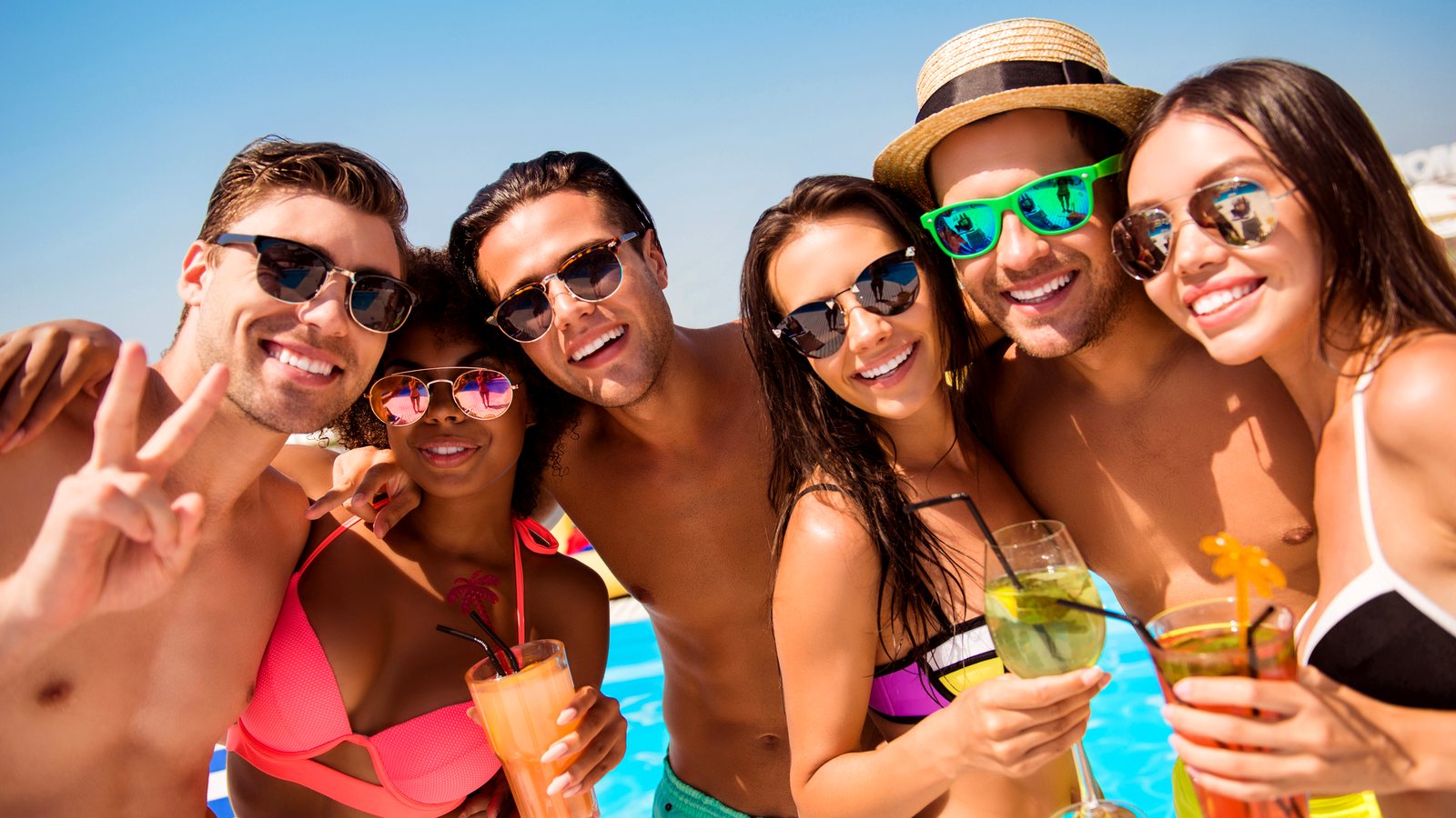 Friends celebrating with drinks at the beach